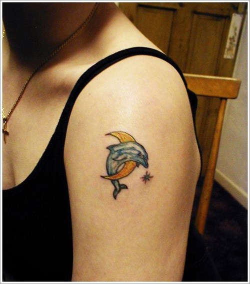 Colorful Dolphin With Half Moon Tattoo On Girl Left Shoulder