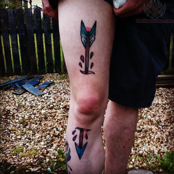 Colorful Ripped Skin Arrow Tattoo On Right Knee