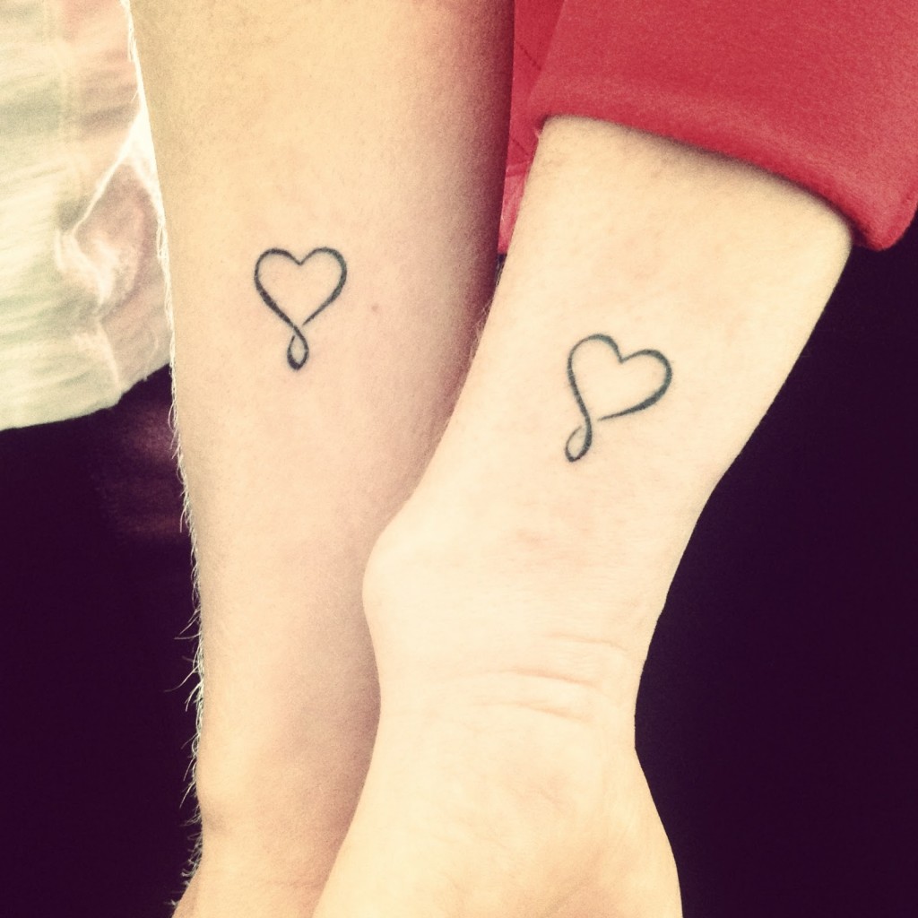 Cute Black Heart Tattoo On Couple Wrist
