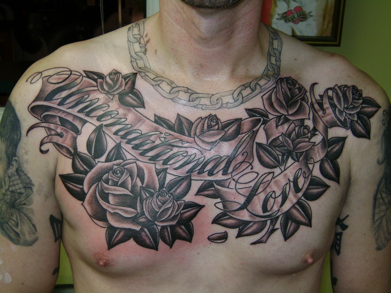 Dark Grey Rose Flowers And Unconditional Banner Tattoo On Chest For Men