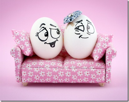 Funny Egg Couple Sitting On Sofa