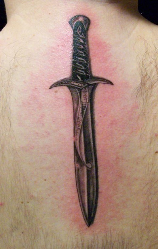 Grey Realistic Knife Tattoo On Upper Back