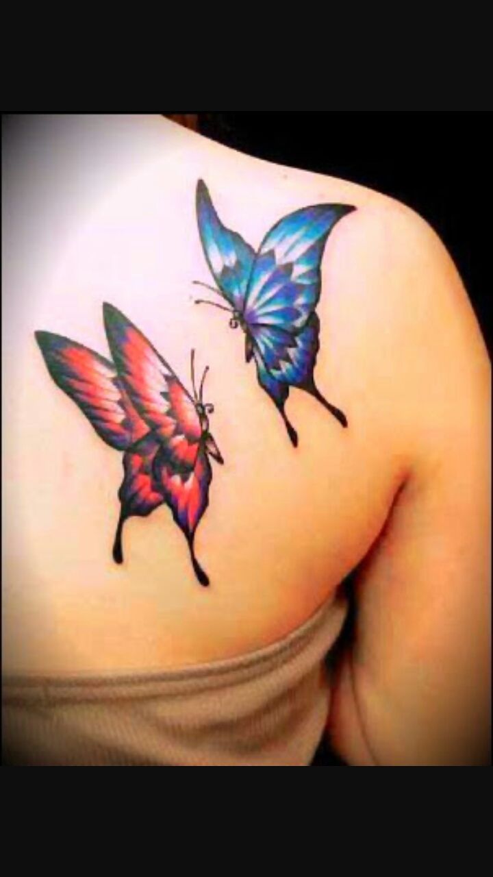 Red And Blue Two Flying Butterflies Tattoo On Girl Back Shoulder