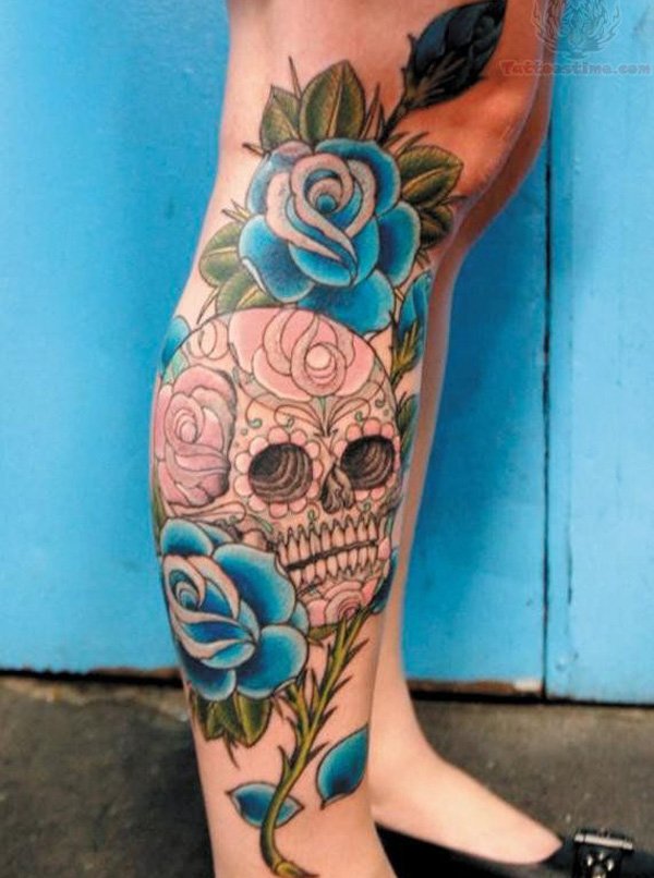 Two Blue Roses With Skull Tattoo On Girl Leg