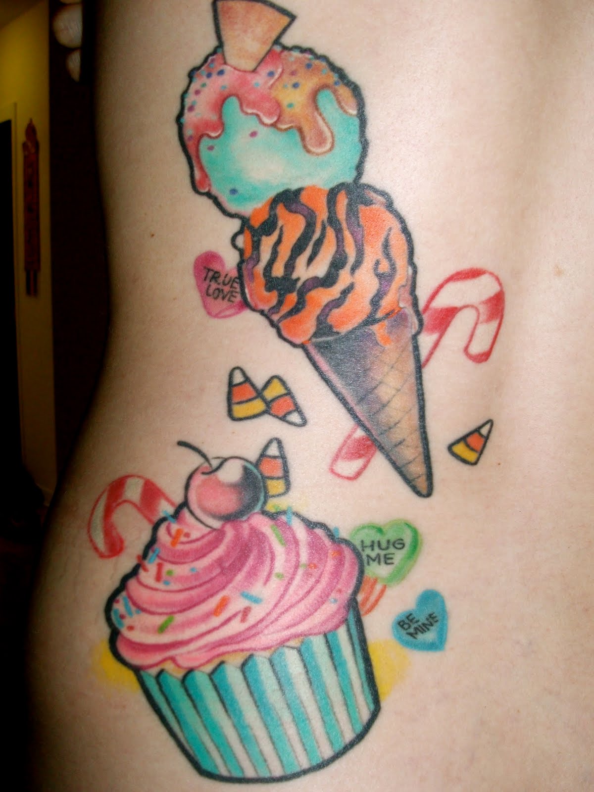Awesome Cupcake With Softy Tattoo On Side Rib