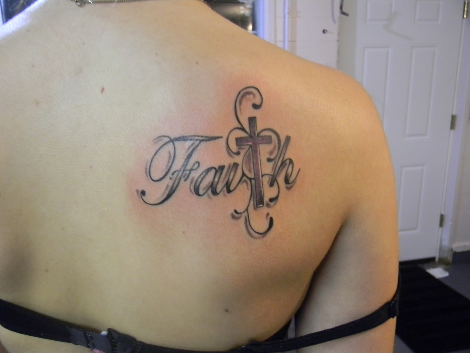 Black And Grey Faith With Cross Tattoo On Girl Upper Back