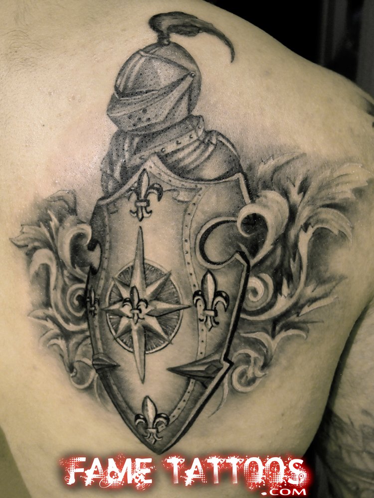 Black And Grey Warrior Mask With Family Crest Tattoo On Back Shoulder