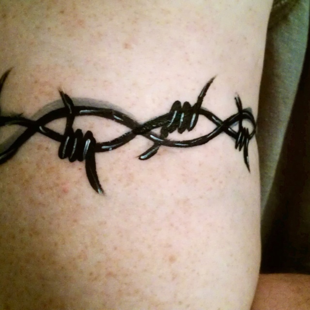 Black Barbed Wire Tattoo On Biceps