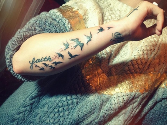 Black Faith With Flying Birds Tattoo On Forearm