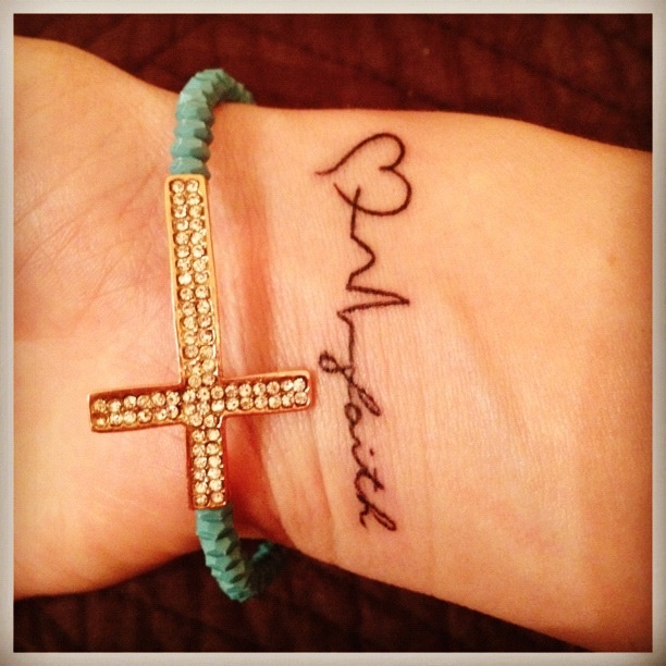 Black Faith With Heart And Heartbeat Tattoo On Girl Wrist