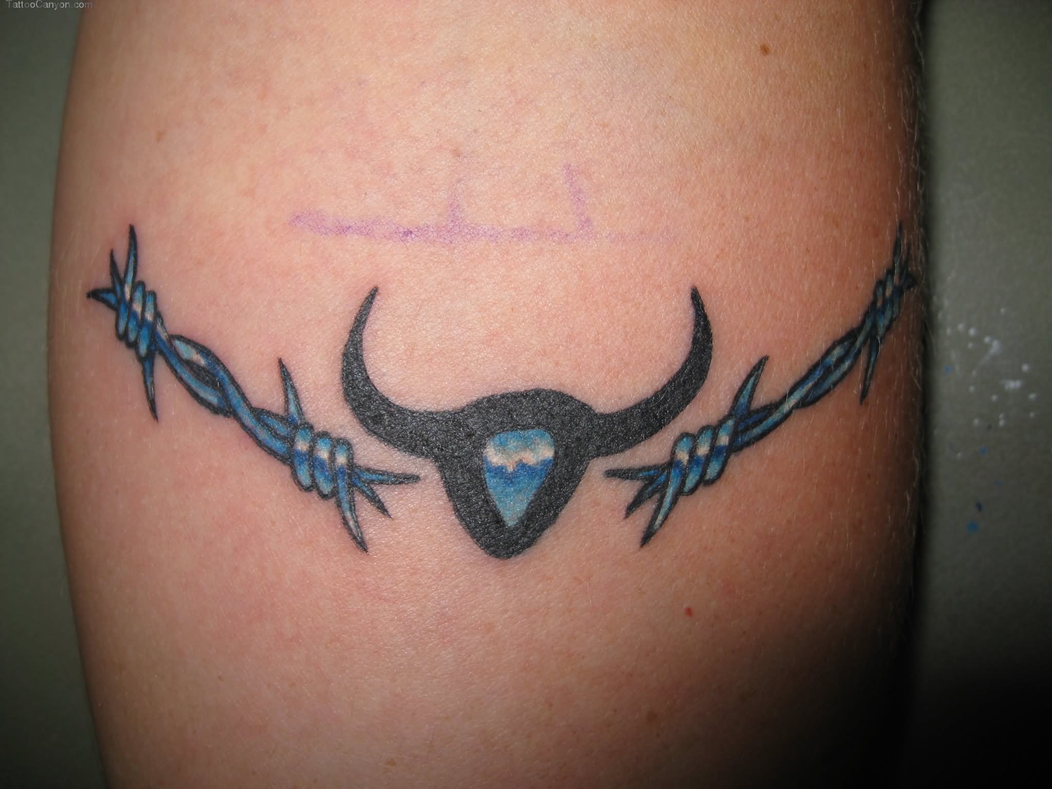 Black Tribal Bull And Blue Barbed Wire Tattoo On Bicep
