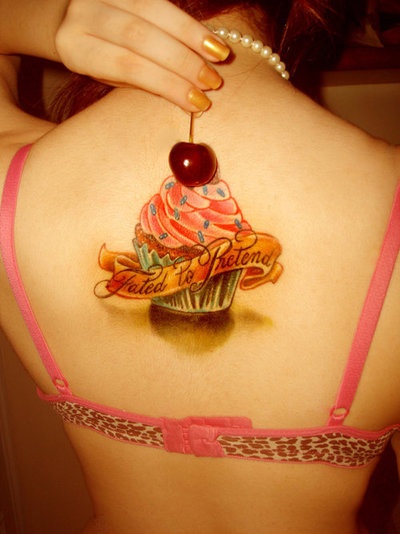 Cherry On Cupcake With Banner Tattoo On Girl Upper Back