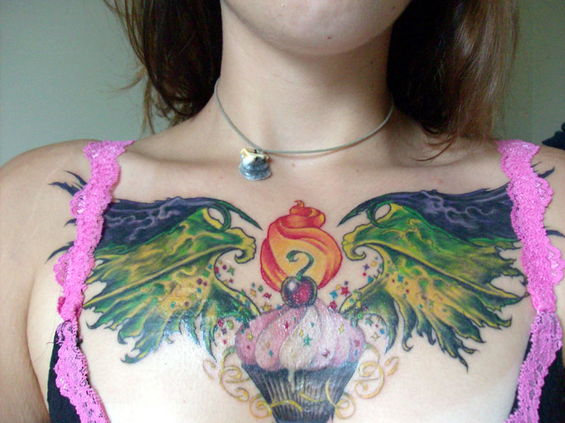 Colorful  Cupcake With Wings Tattoo On Girl Chest