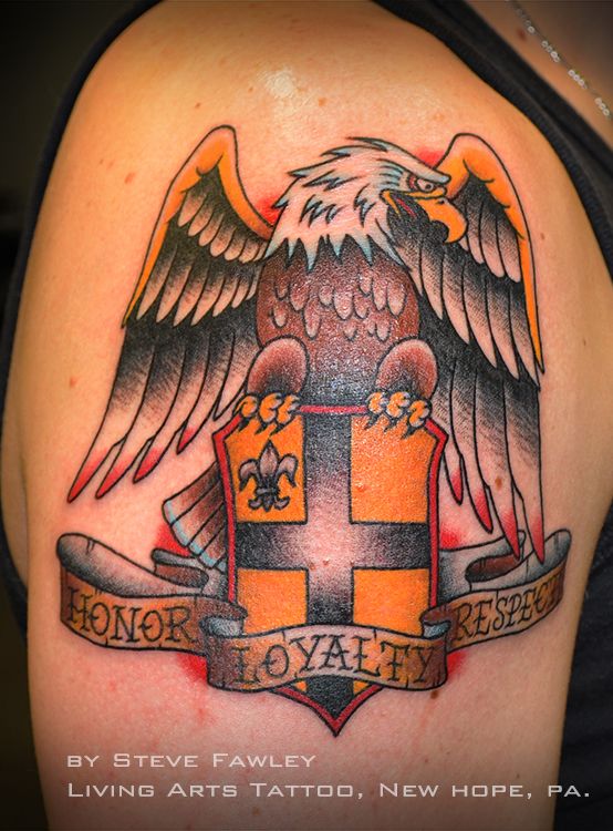 Colorful Eagle Sit On Family Crest Tattoo On Shoulder By Steve Fawley