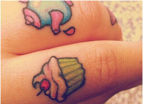 Colorful Tiny Cupcake Tattoo On Finger