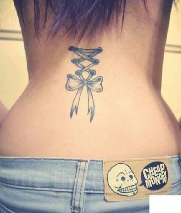 Cute Grey Ink Corset Bow Tattoo On Girl Back