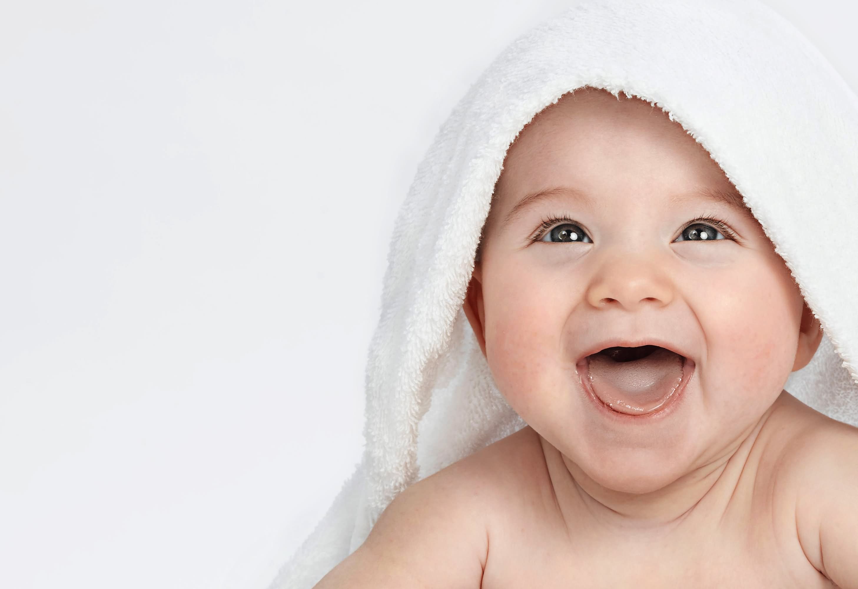 Cute Smiling Baby Lying Under Towel