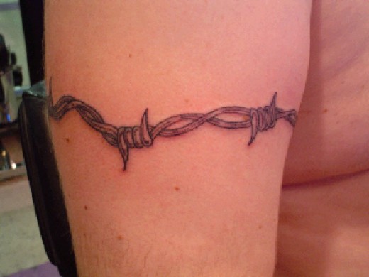 Grey Barbed Wire Tattoo On Man Right Bicep