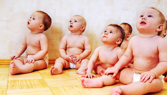 Group Of Babies Looking Upside