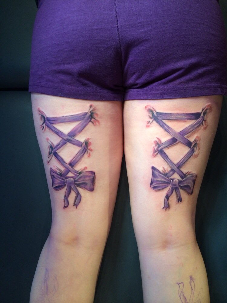 Purple Corset Bow Tattoo On Back Both Thighs