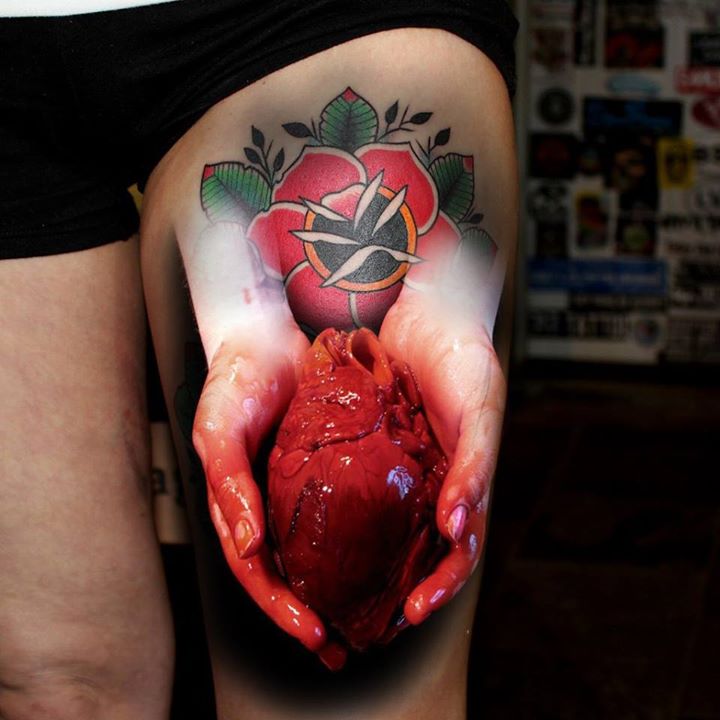 Realistic 3D Blooded Heart In Hands Tattoo on Thigh