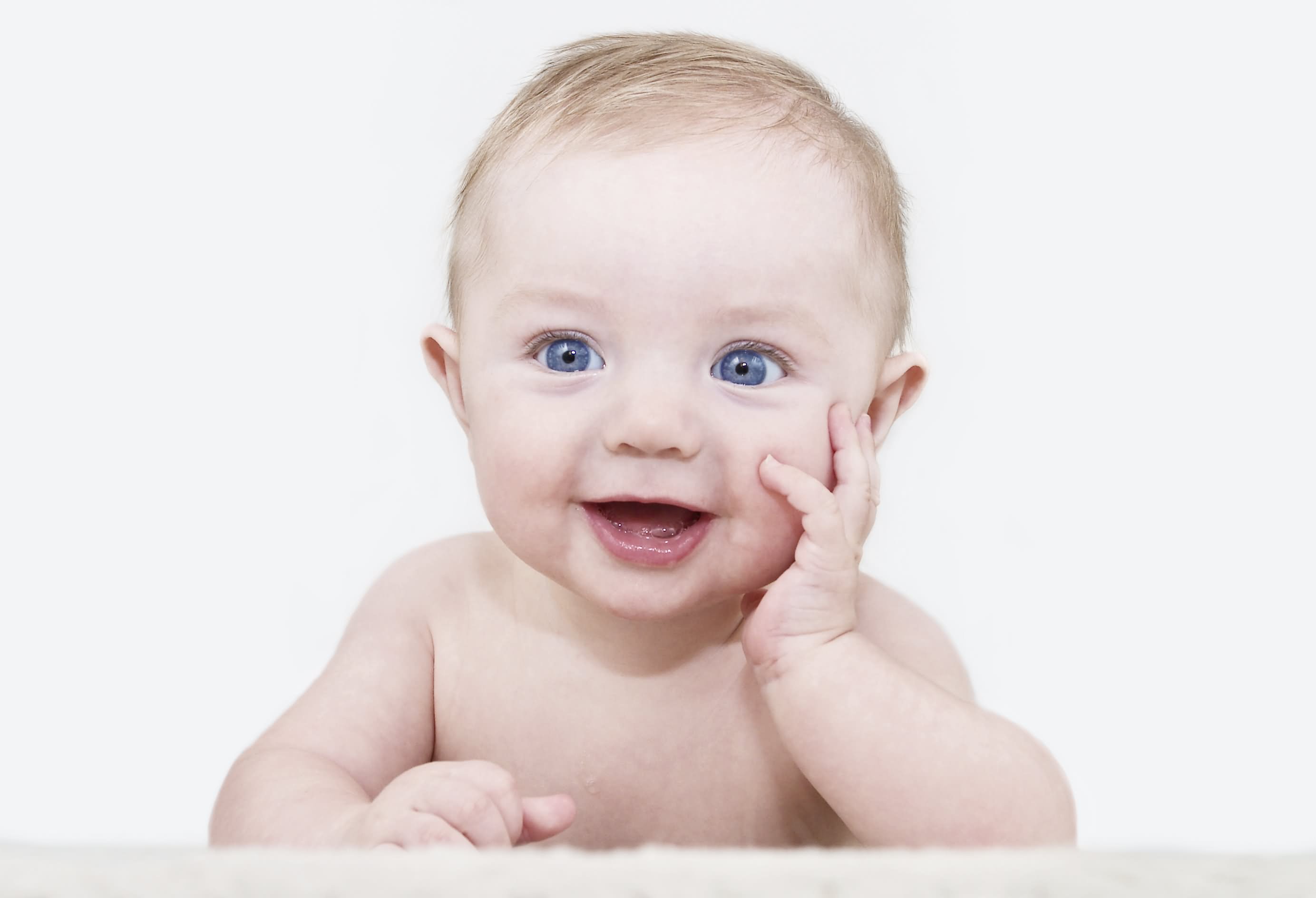 Sweet Baby With Blue Eyes Posing For Photograph