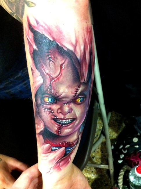 3D Ripped Skin Horror Chucky Head Tattoo On Forearm