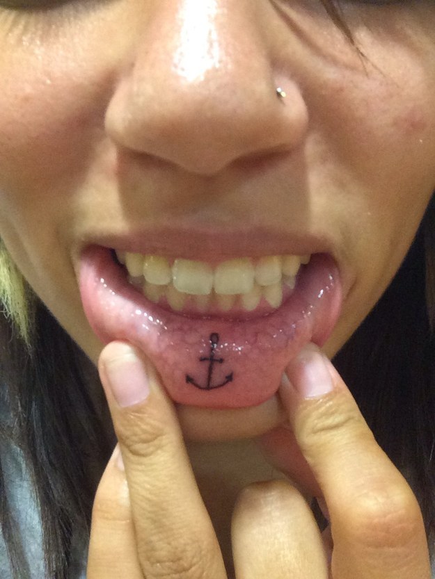 Black Anchor Tattoo On Girl Inner Lip