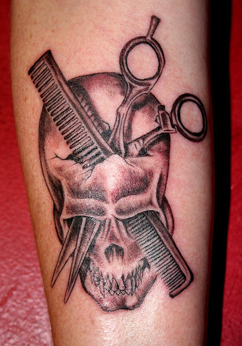 Black And Grey Comb And Scissor In Skull Tattoo On Forearm