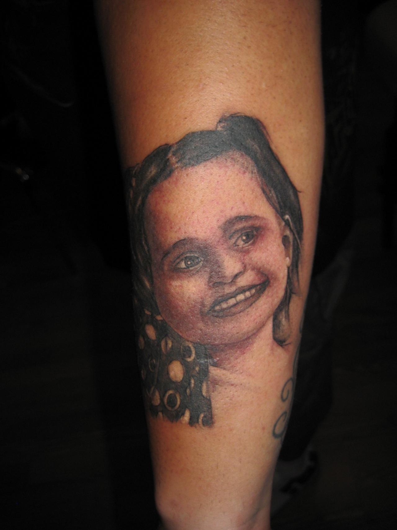 Black And Grey Daughter Face Tattoo On Forearm