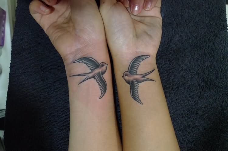 Black And Grey Flying Sparrow Tattoo On Sisters Wrist