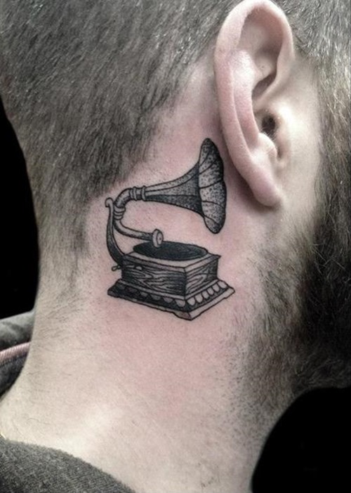 Black And Grey Gramofon Tattoo On Man Behind The Ear