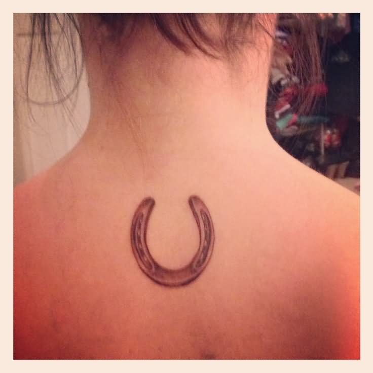 Read Complete Black And Grey Horseshoe Tattoo On Girl Upper Back