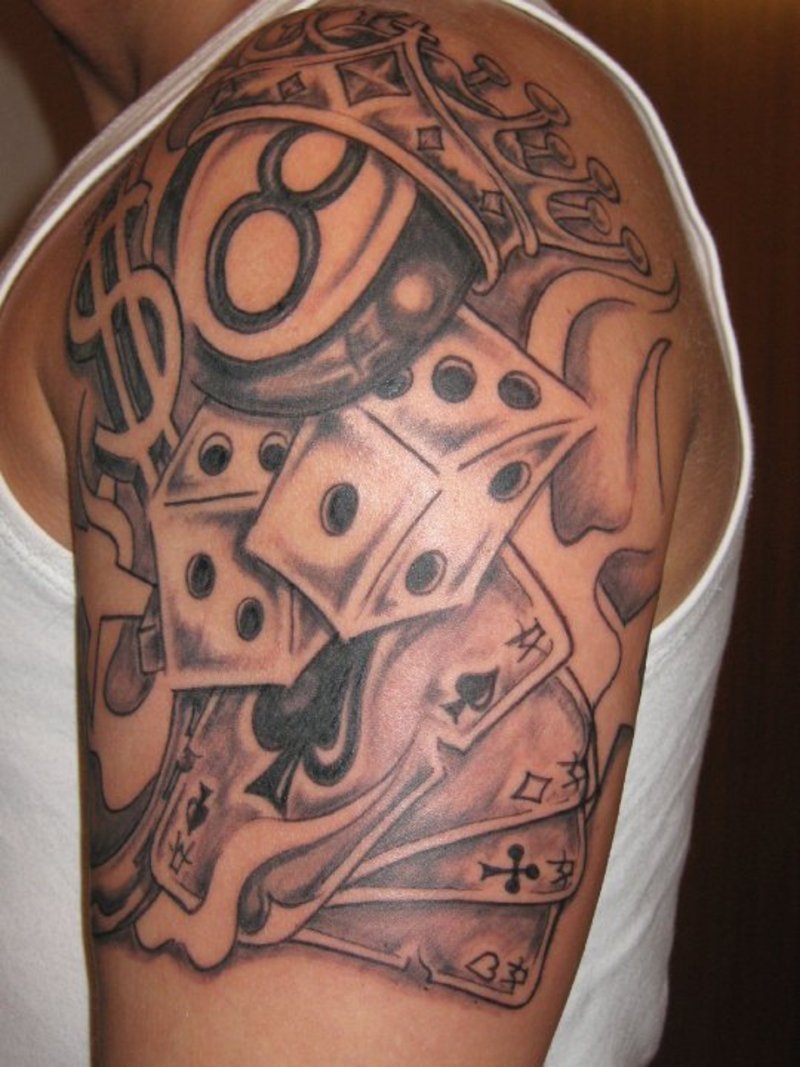 Black And Grey Money Symbol With Playing Cards And Dice Tattoo On Man Shoulder