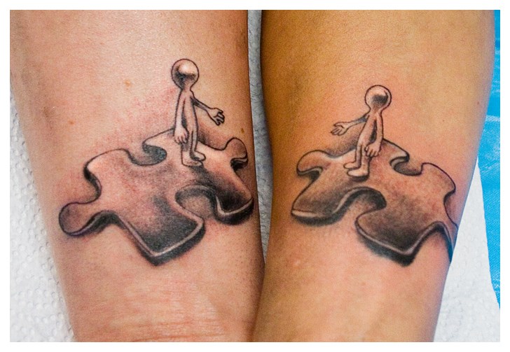 Black And Grey Puzzle Piece Tattoo On Couple Wrist