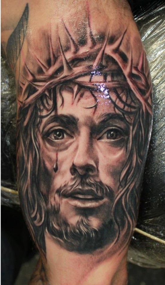 Black And Grey Religious 3D Jesus Face With Thorn Crown Tattoo On Bicep