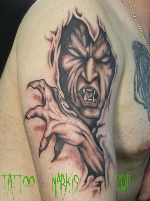 Black And Grey Ripped Skin Monster Face Tattoo On Man Shoulder By Constantin