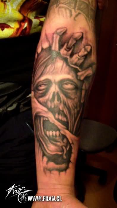 Black And Grey Ripped Skin Zombie Face Tattoo On Forearm