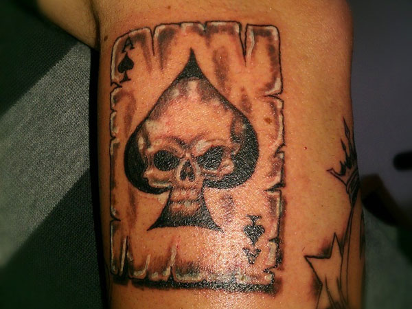 Black And Grey Skull In Ace Of Spade Tattoo On Leg