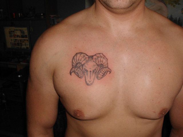 Black And Grey Zodiac Aries Tattoo On Man Chest