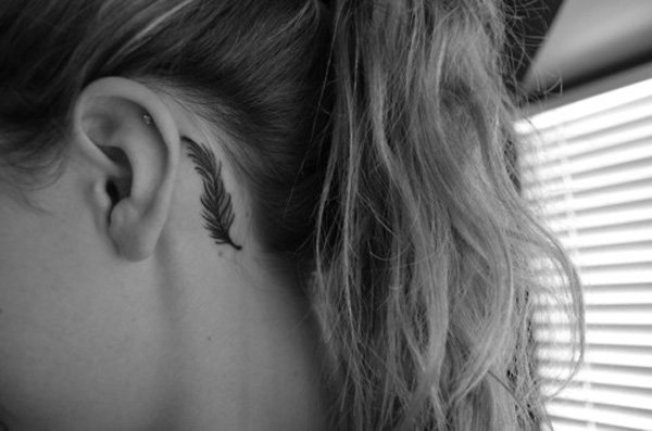 Black Feather Tattoo On Girl Behind The Ear