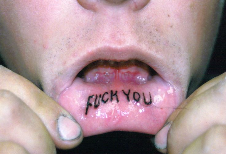 Black Fuck You Tattoo On Inner Lip