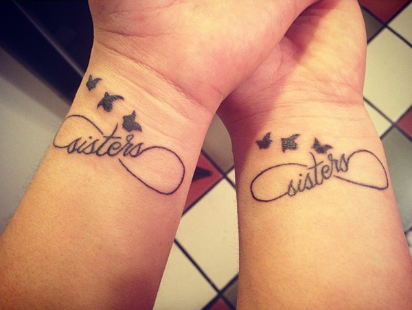 Black Infinity Sisters With Flying Birds Tattoo On Wrists