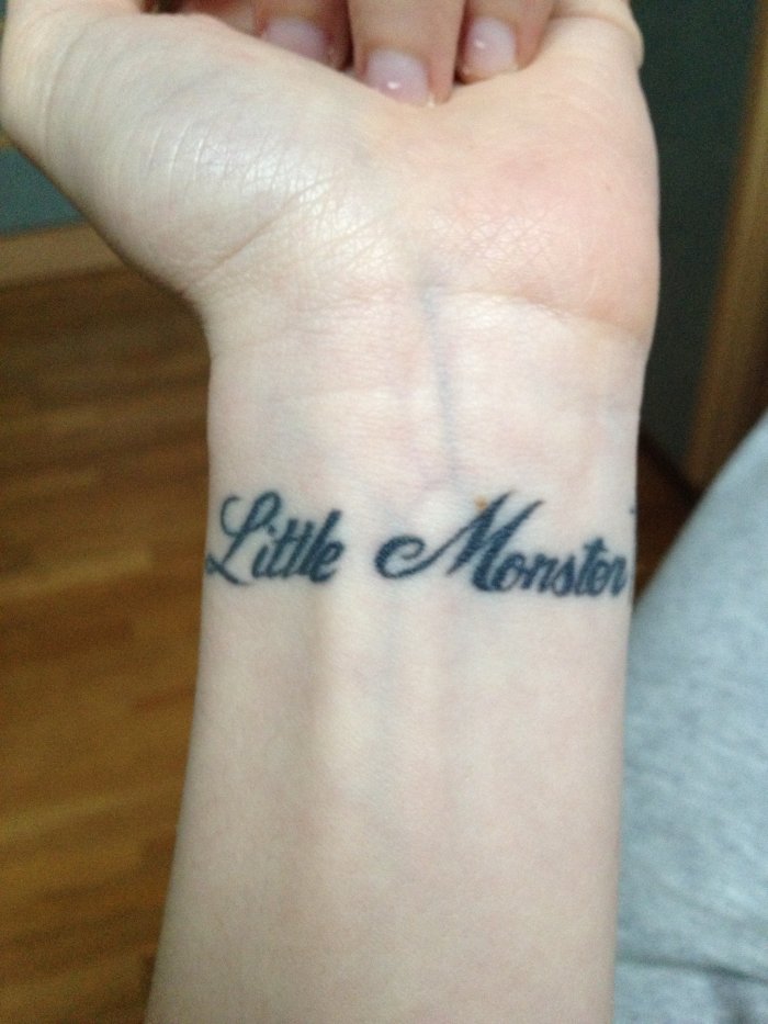 Black Little Monster Tattoo On Wrist