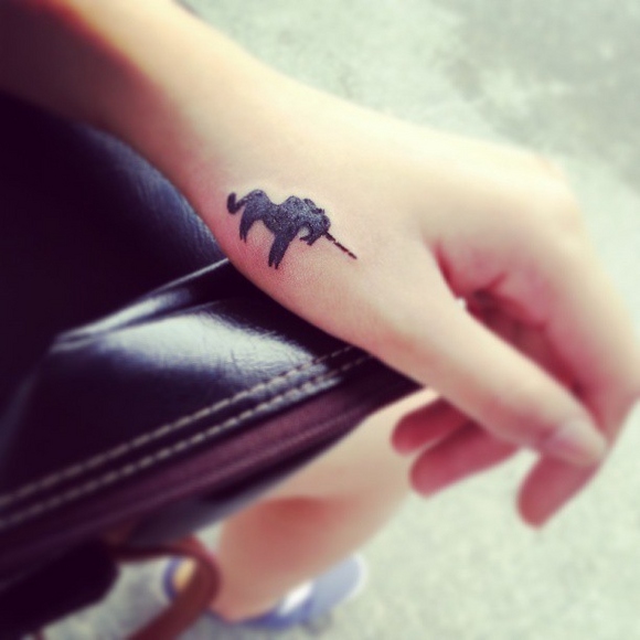 Black Little Unicorn Tattoo On Hand