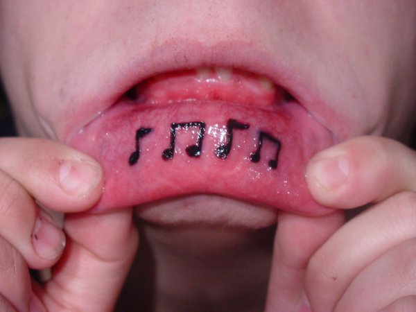 Black Music Note Tattoo On Inner Lip