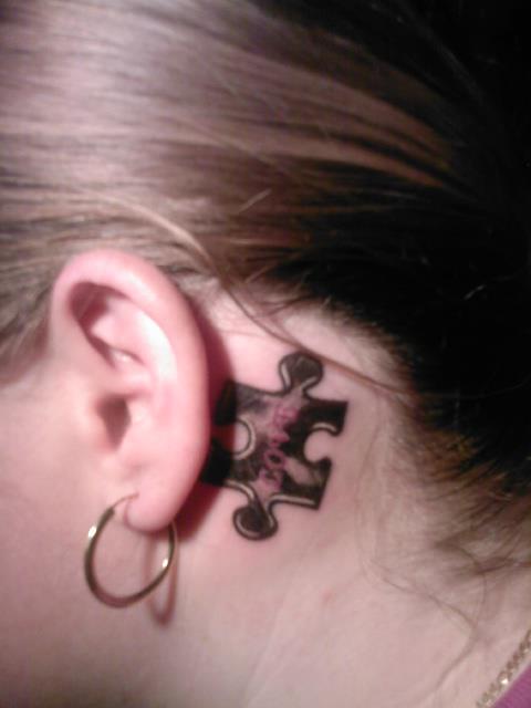 Black Puzzle Tattoo On Girl Behind The Ear