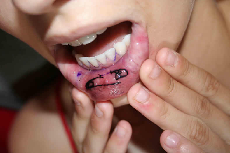 Black Safety Pin Tattoo On Girl Inner Lip
