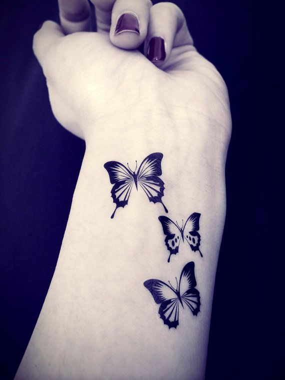 Black Three Flying Butterflies Tattoo On Wrist For Sister