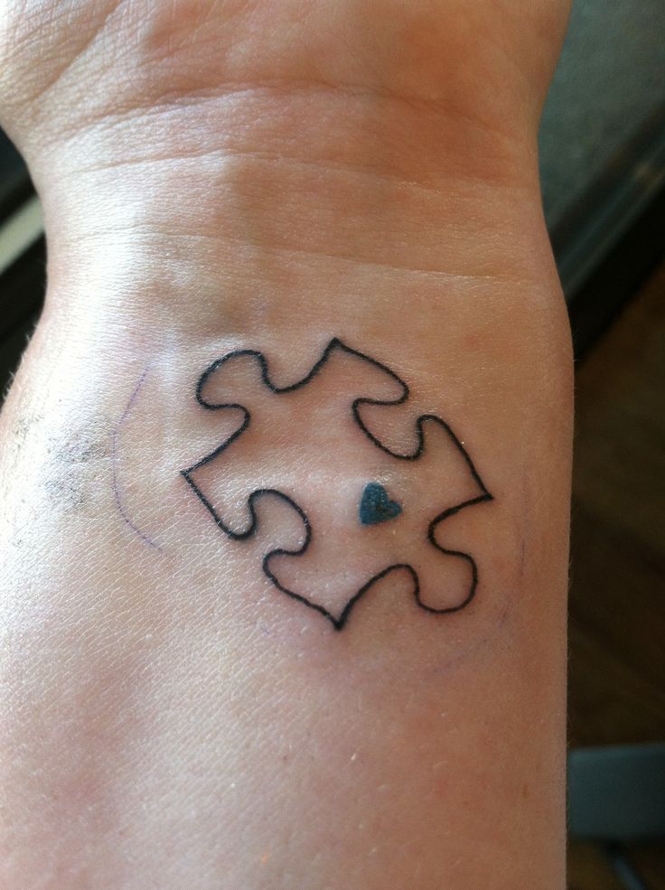 Black Tiny Heart In Puzzle Piece Tattoo On Wrist